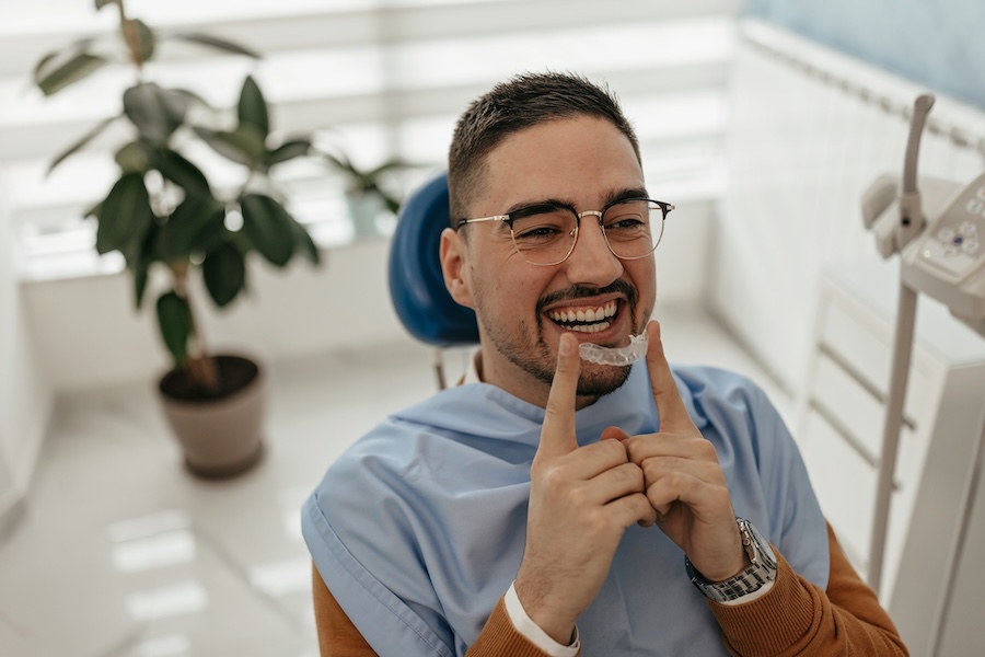 suresmile clear aligners, man in dental chair with clear aligners